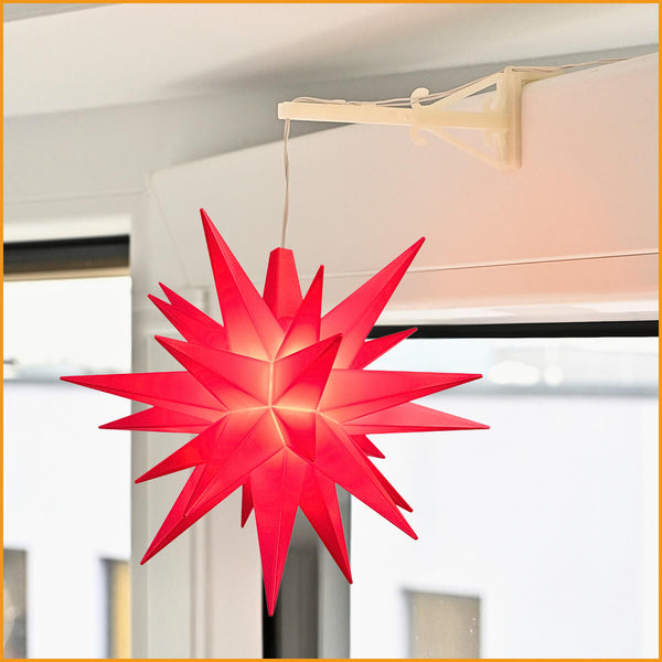 Roter Herrnhuter Stern 13 cm am Fenster mit Fensterhalter